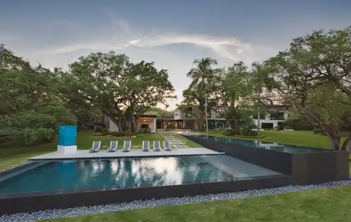 Dark-edged pool set in a lawn under live oaks at Journeys End