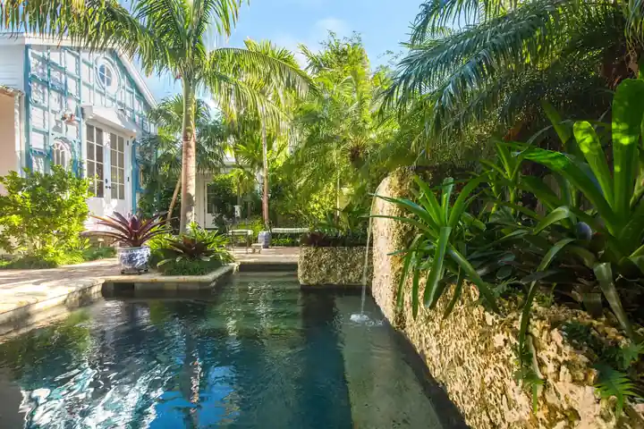 Courtyard plunge pool with a coral stone wall spout in Old Town Key West